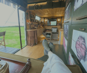 The open area, elevator bed and drop-down patio make this tiny house look spacious and comfortable