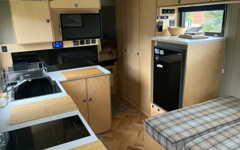 The view from the habitation door, showing the kitchen on the left, seating area on the right and the corridor leading to the bathroom on the left and bedroom at the back