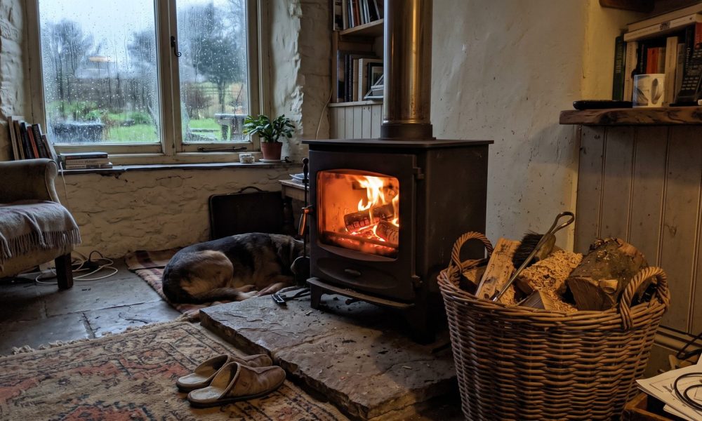Lit wood burning stove in a cottage living room, the kind of stove the ban rumours are about