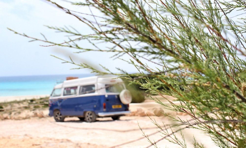 Camper van parked by a beach